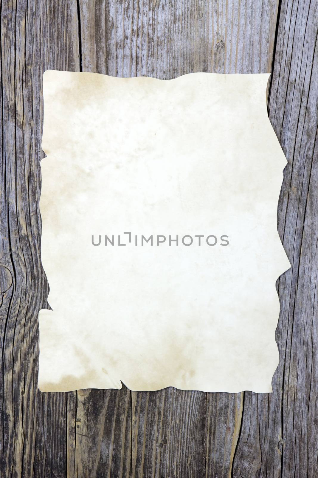 Old paper sheet on wooden background 