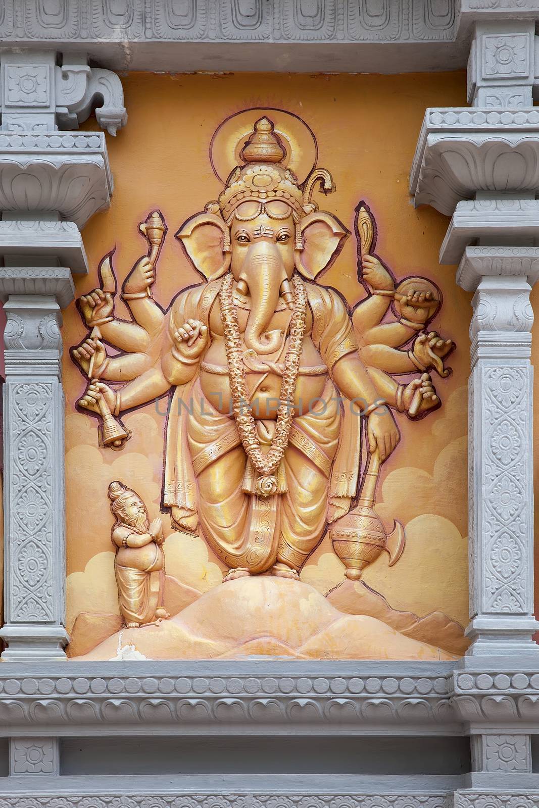 Hindu God Ganesh with Many Arms Carved Wall Relief on Exterior of Hindu Temple