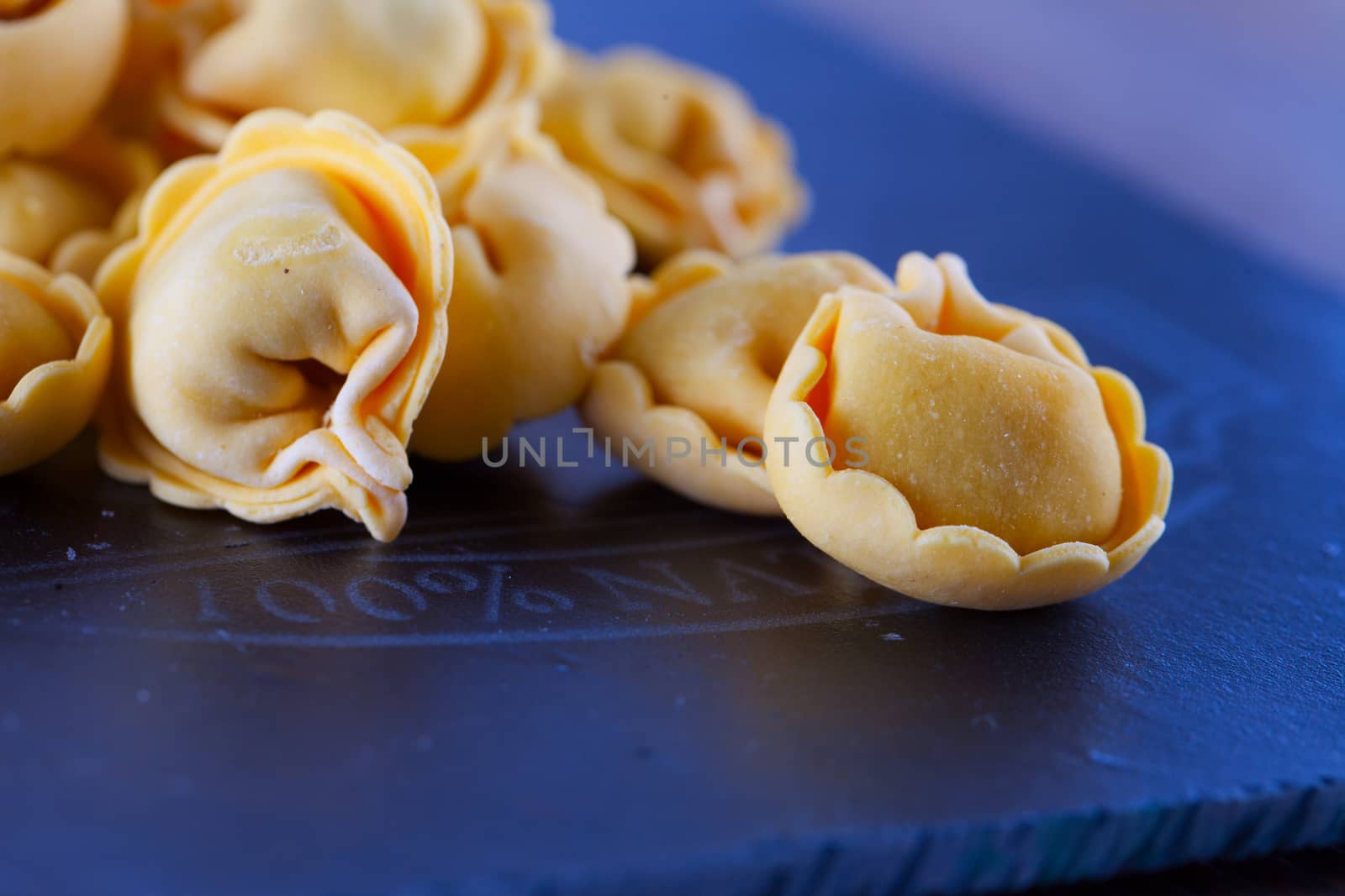 Agnolotti over black chopping board, close up