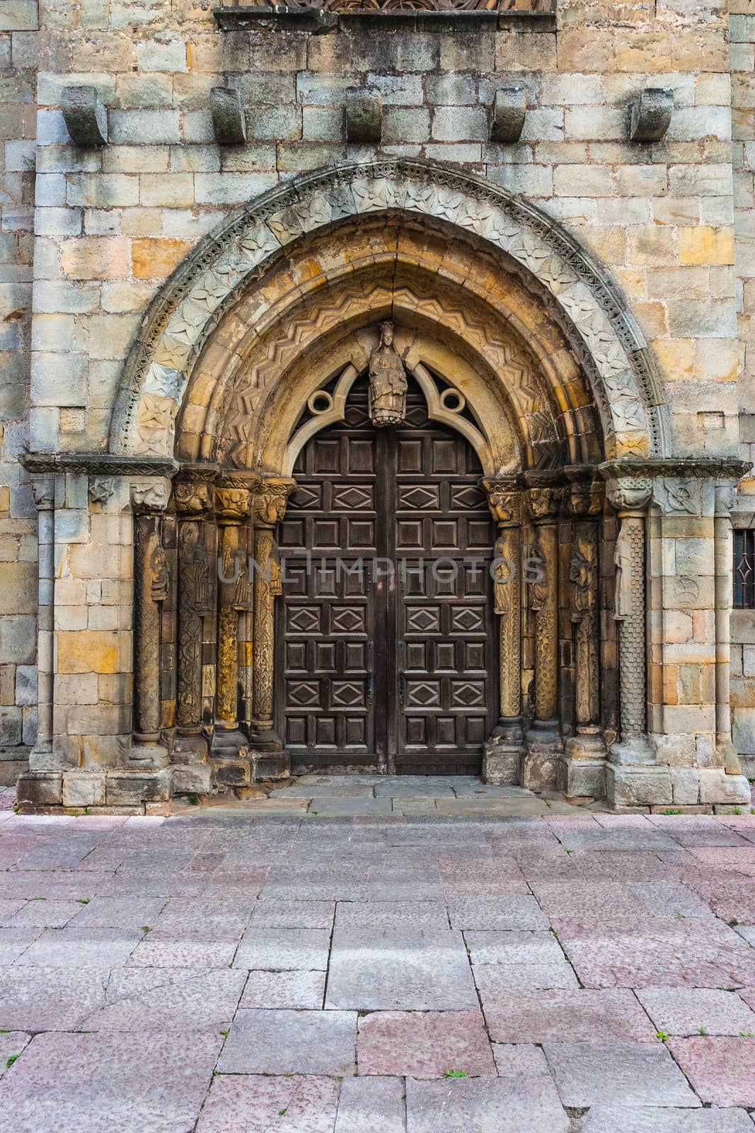 Beautiful Romanesque main entrance in the church of Santa Maria de la Oliva in the town of Villaviciosa Spain