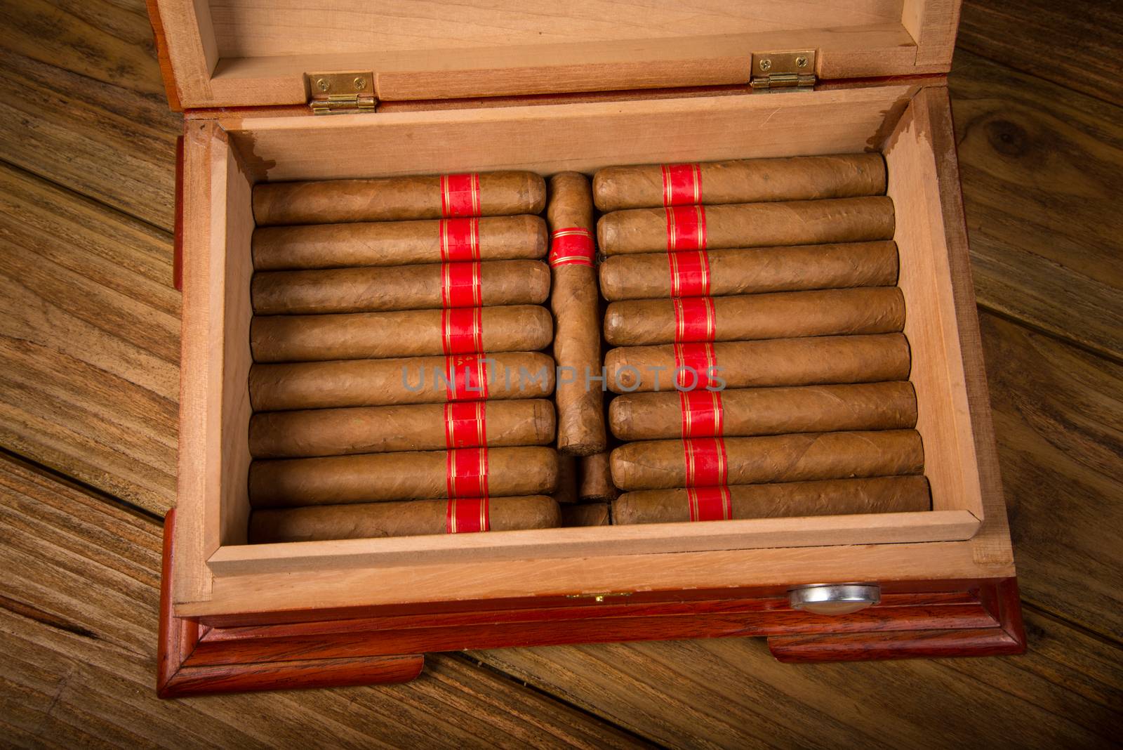 Cuban cigars and humidor on rustic wooden table