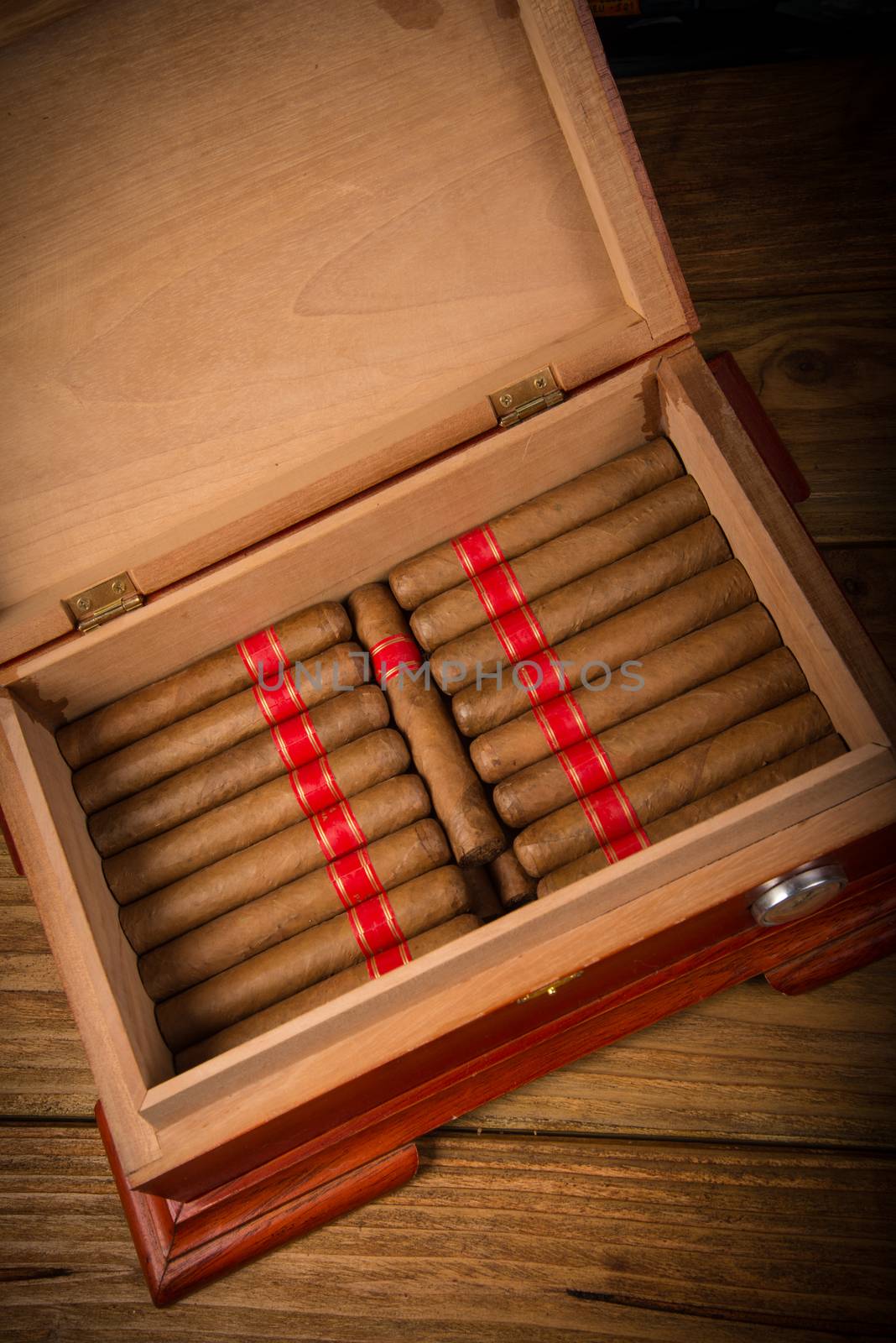 Cuban cigars and humidor on rustic wooden table