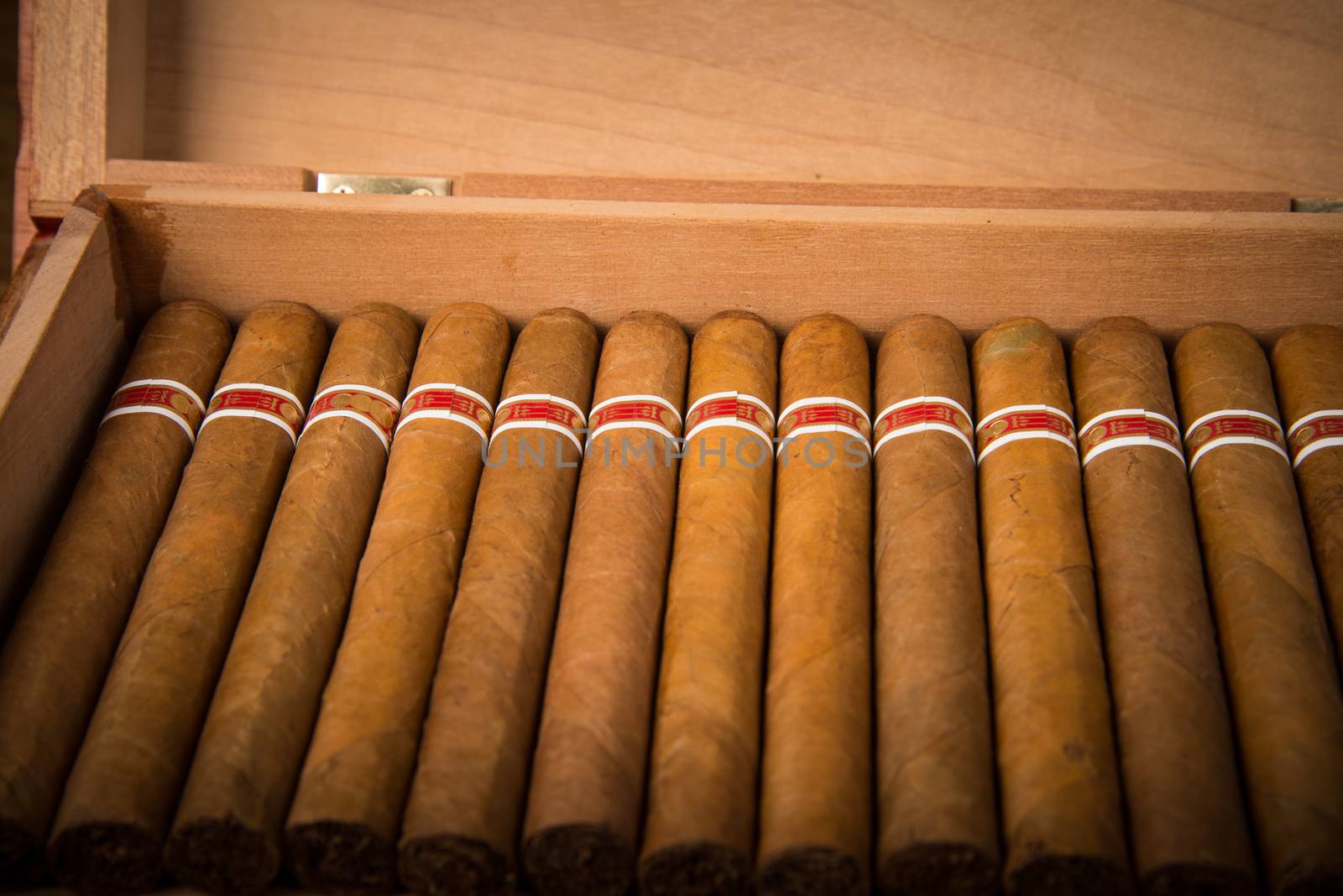 Cuban cigars and humidor on rustic wooden table