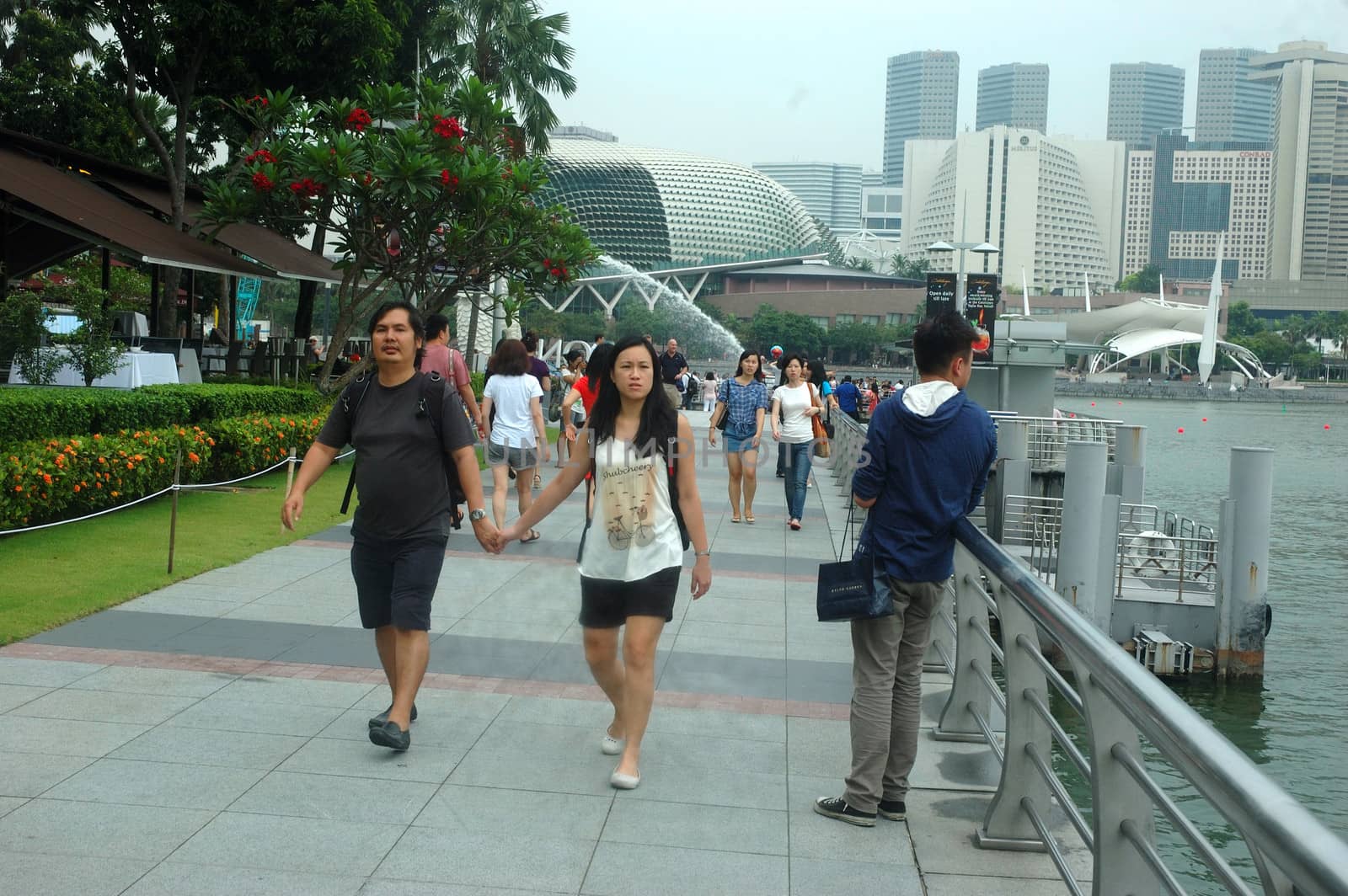 Singapore, Singapore - April 14, 2013: People crowd at One Fullerton, Singapore.