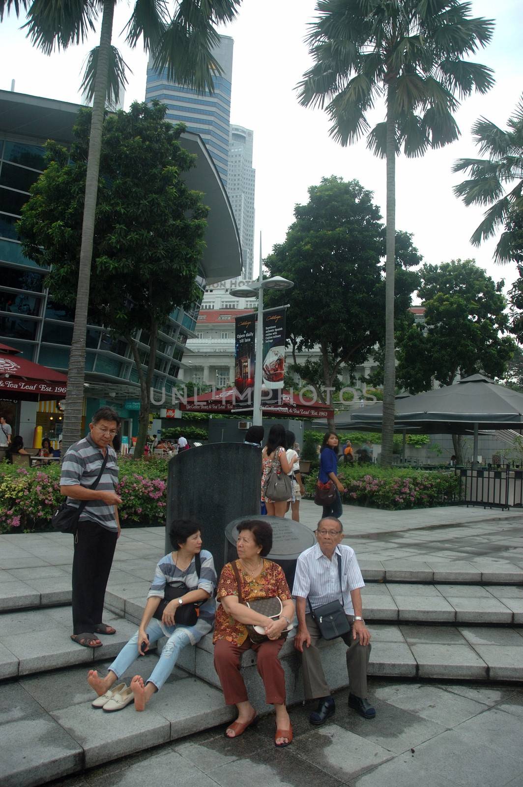 Singapore, Singapore - April 14, 2013: People crowd at One Fullerton, Singapore.
