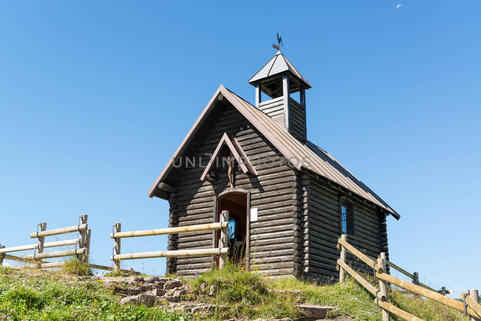 church at the end of the mountain path on the hill in a summer day