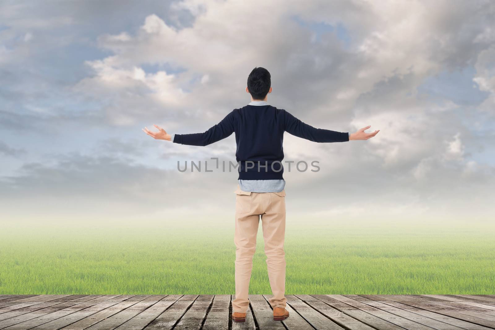 Asian man against grassland with copyspace.