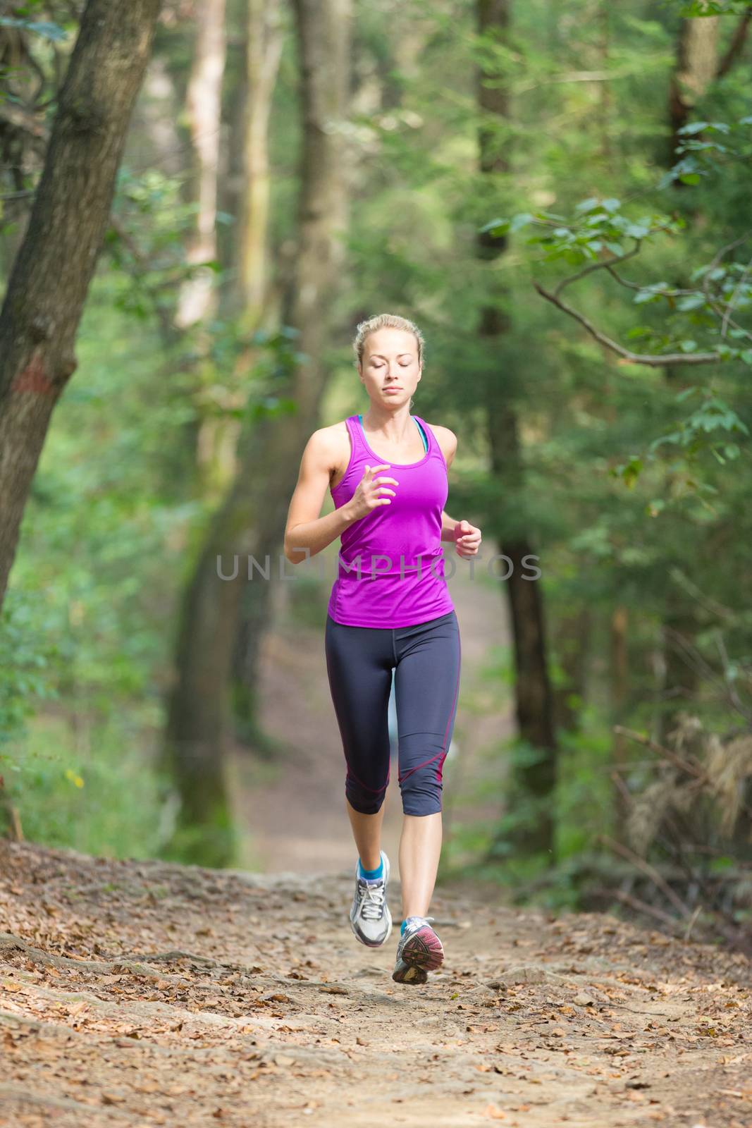 Pretty young girl runner in the forest.  by kasto