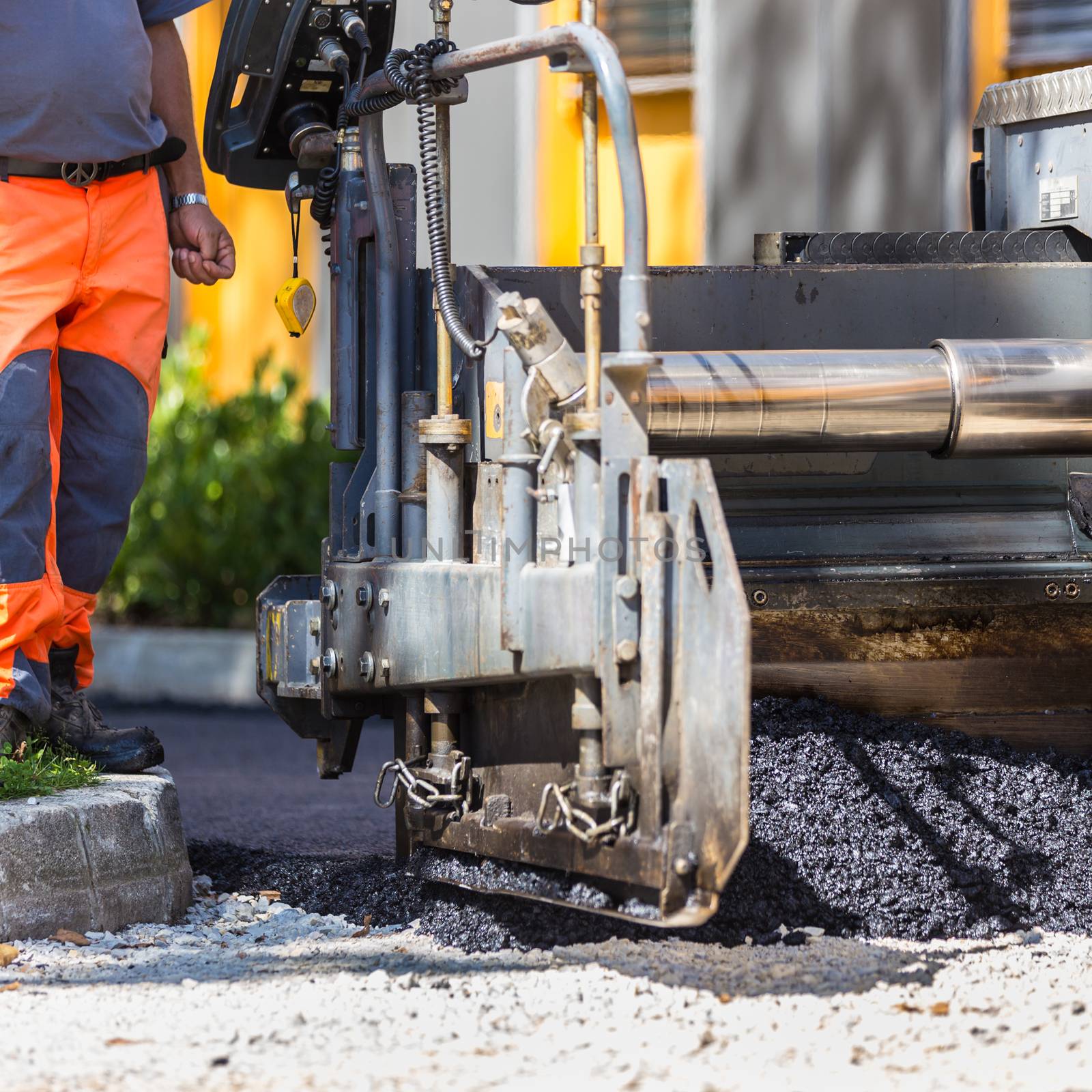 Construction workers during asphalting road works. Manual labor.