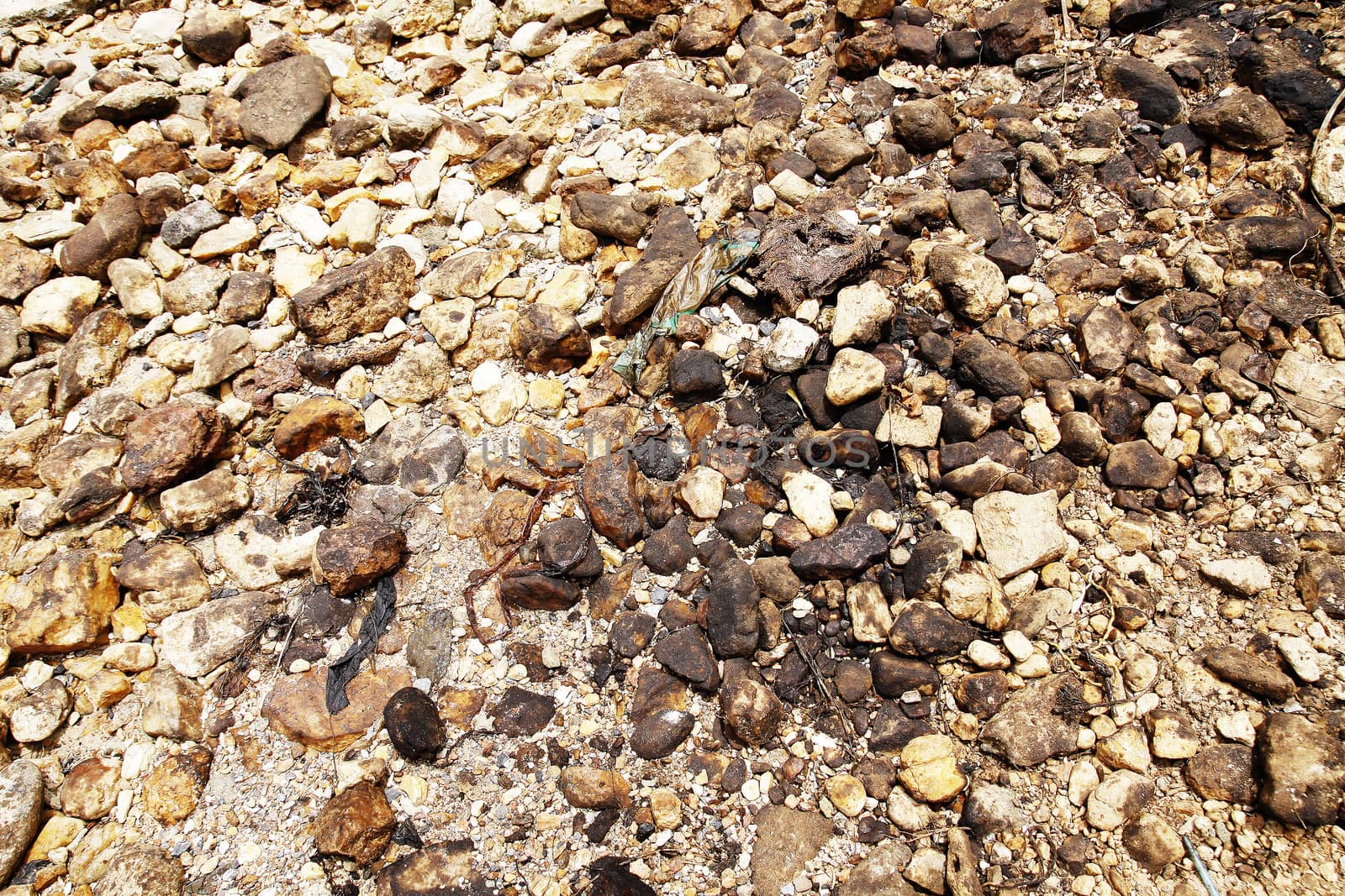 Crude oil spill on the rocks at the beach