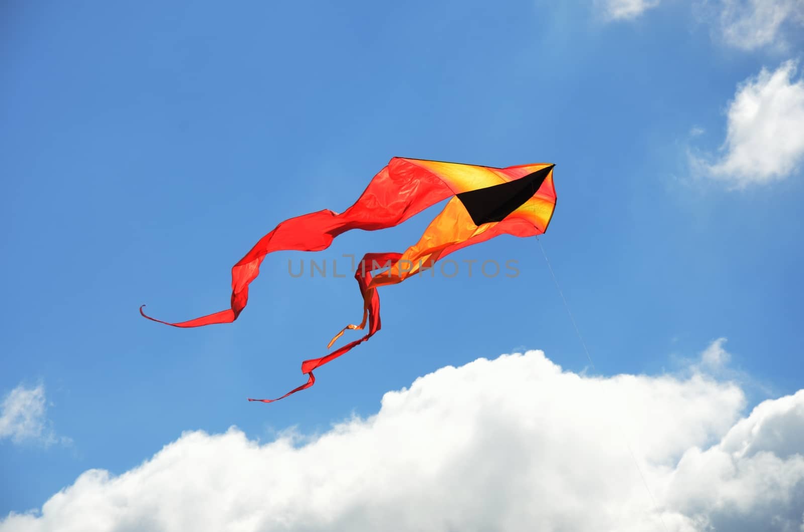 Yellow and orange kite flying