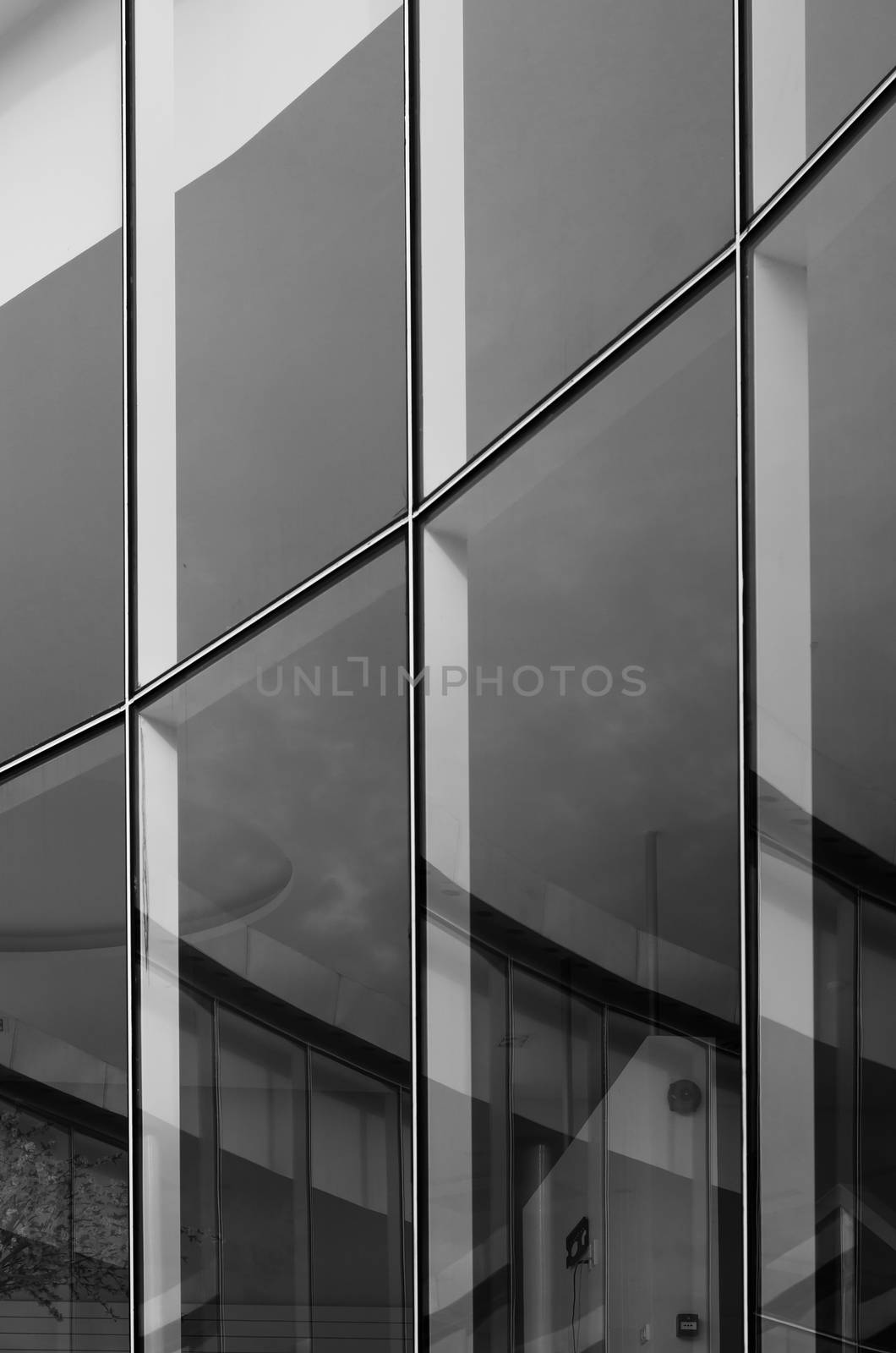 Glass wall building with reflection  by siraanamwong