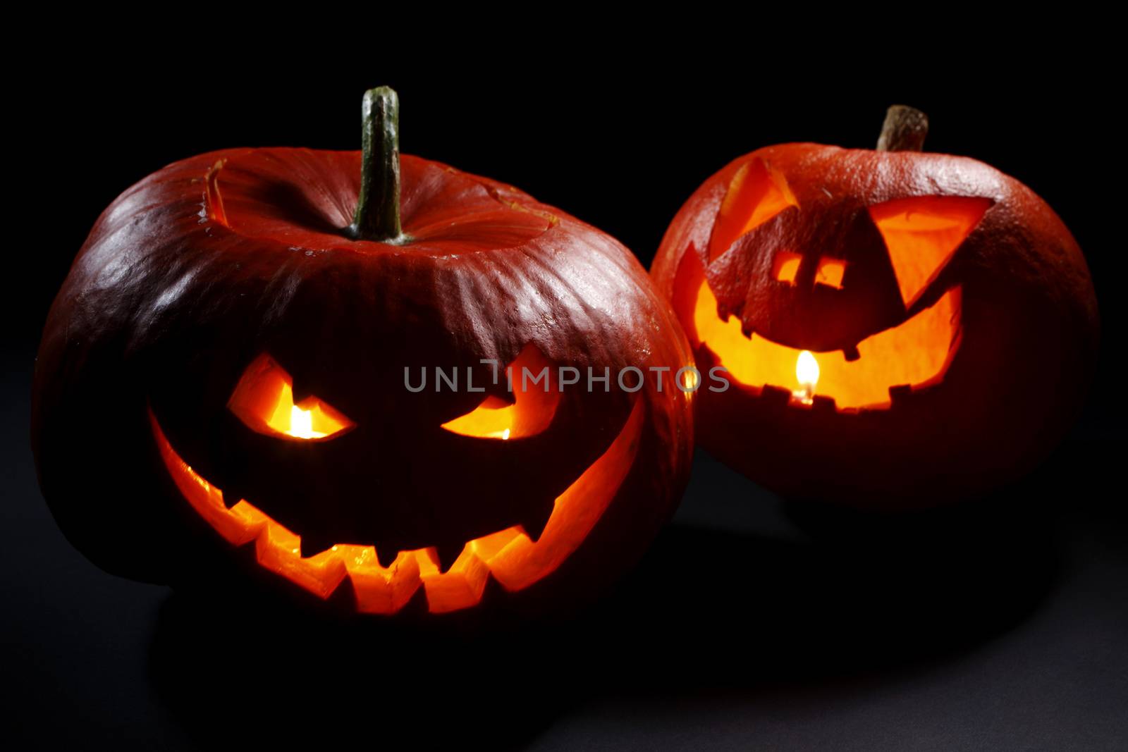 Halloween pumpkin heads jack lantern with scary evil faces on black