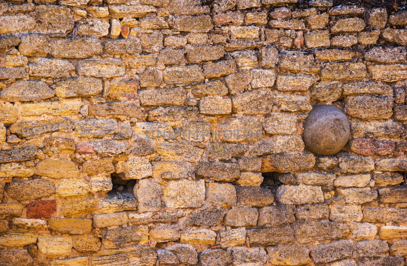 old stone  fortification with the cannonball