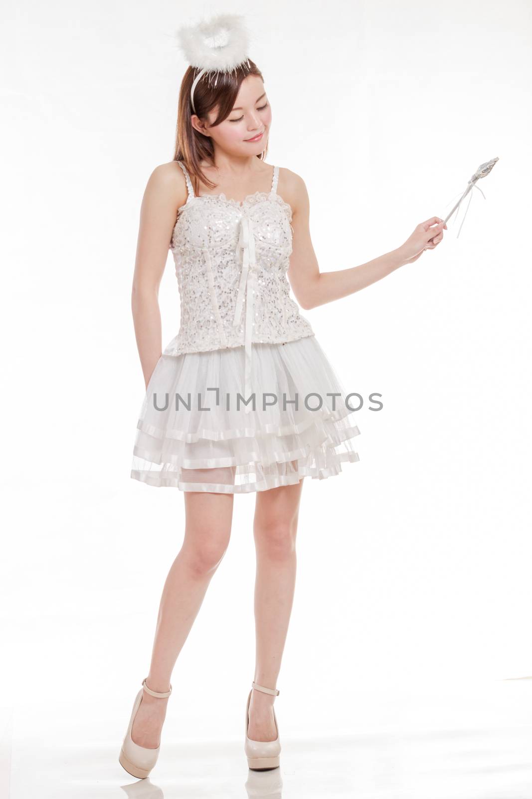 Chinese woman in white angel fairy costume waving her wand