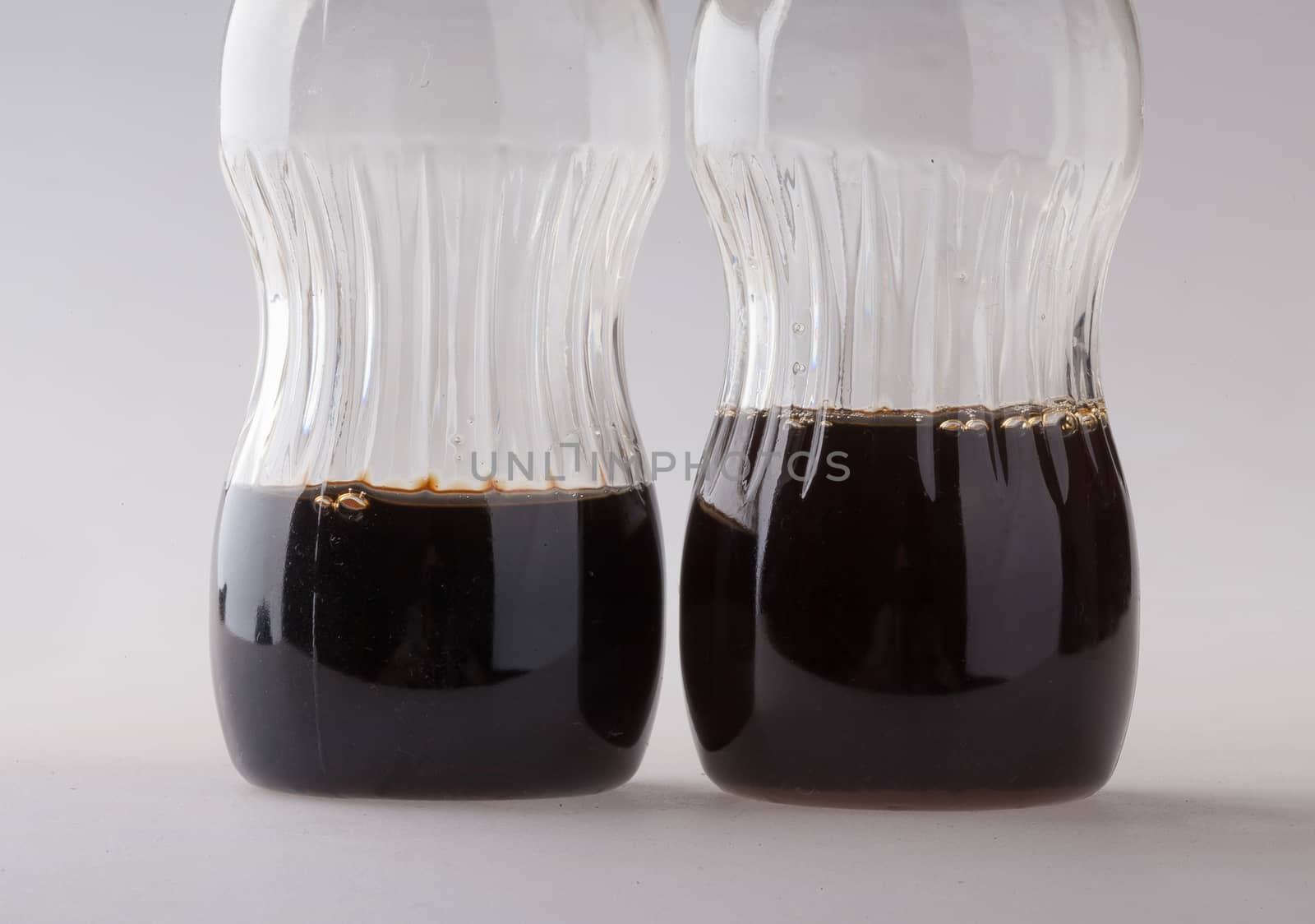 Pair of bottle filled liquid with defferent levels