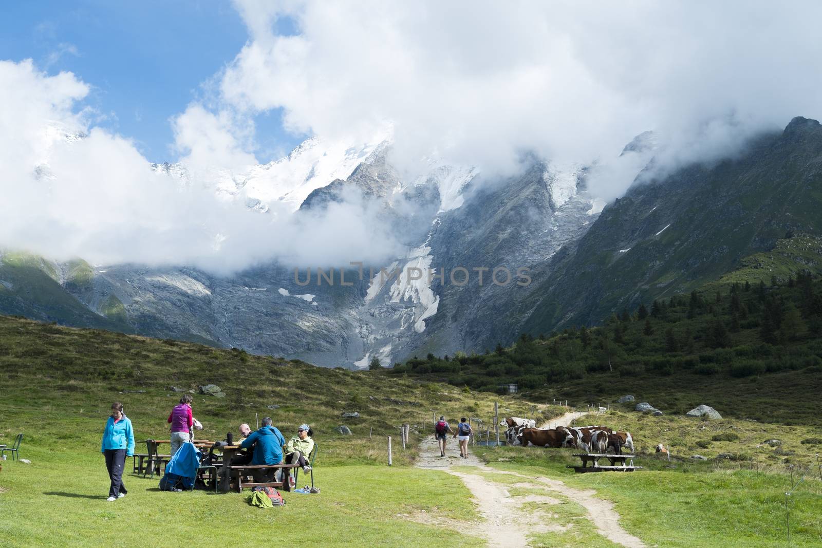 ST-GERVAIS-LES-BAINS, FRANCE - AUGUST 24: Hikers at the Truc Hostel, at bottom of the Domes de Miage mountain. This is one of the stages of the Mont Blanc Tour August 24, 2014 in St-Gervais-les-Bains.