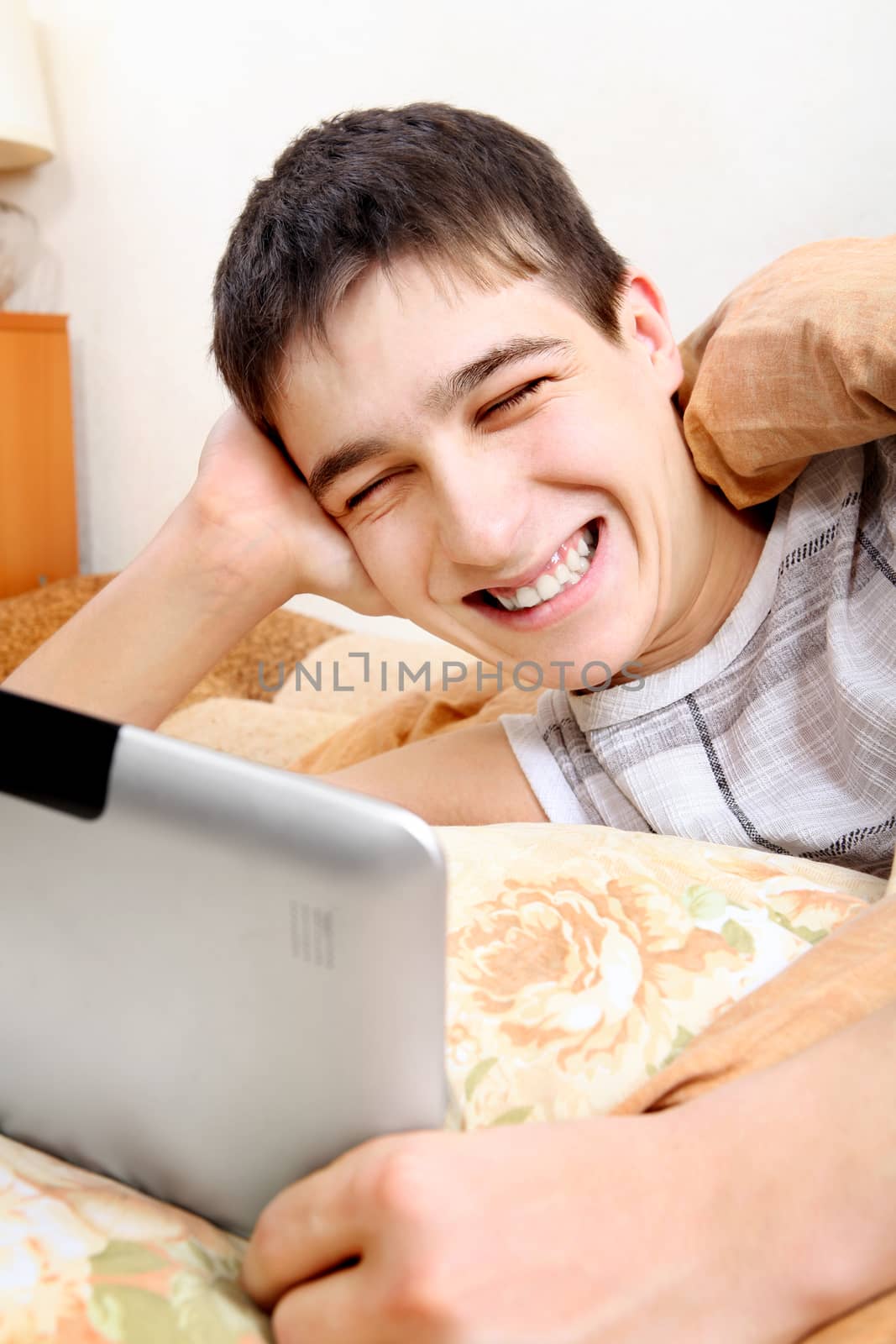 Teenager with Tablet in the Bed by sabphoto