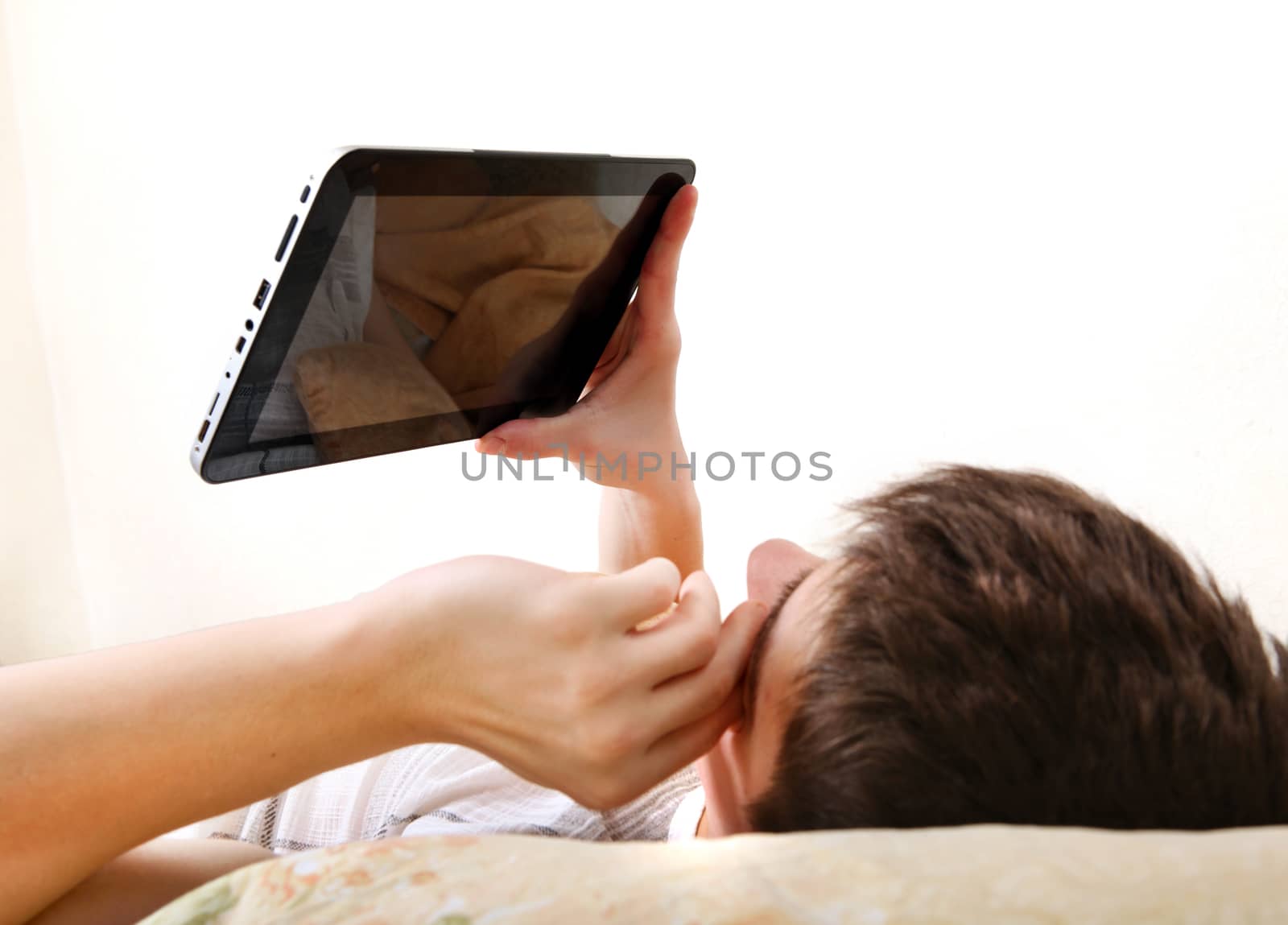 Teenager with Tablet in the Bed by sabphoto