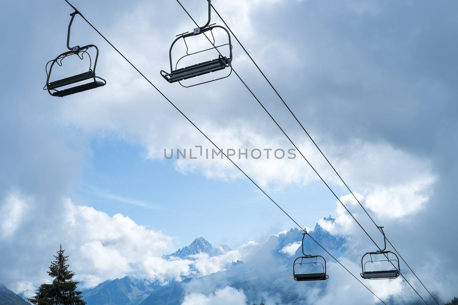Low angle shot of alpine air lift with trees in the background