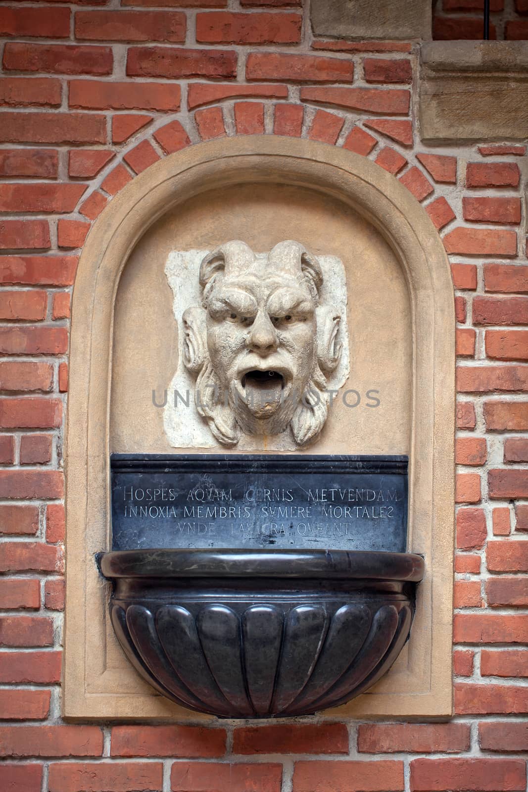 mascaron ornament with sourse of water in collegium maius in cracow in poland