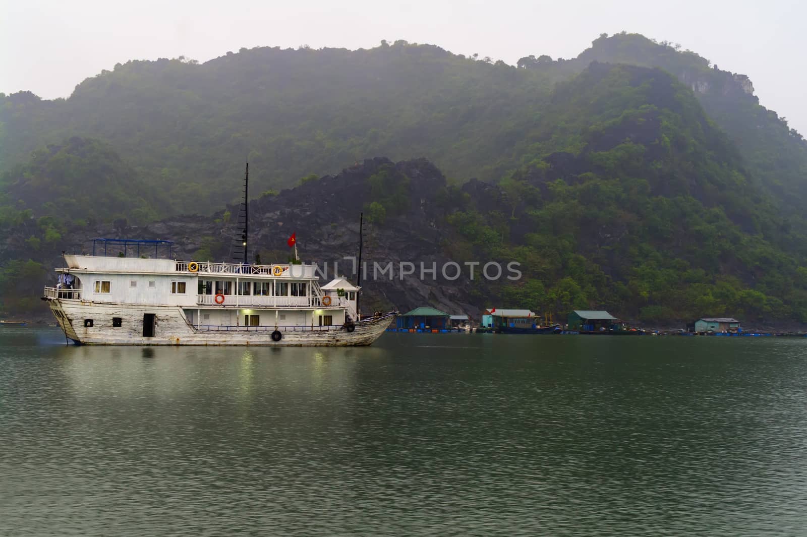 Ship at Anchor Before Dawn in Ha Long Bay, Vietnam.