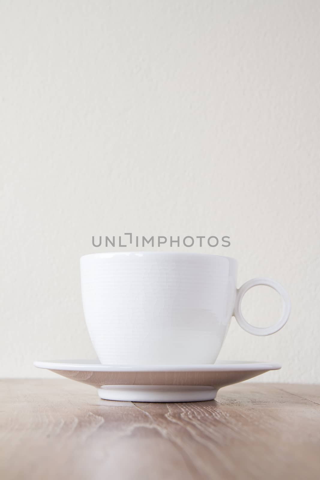 Cup of coffee on wooden table by kasinv