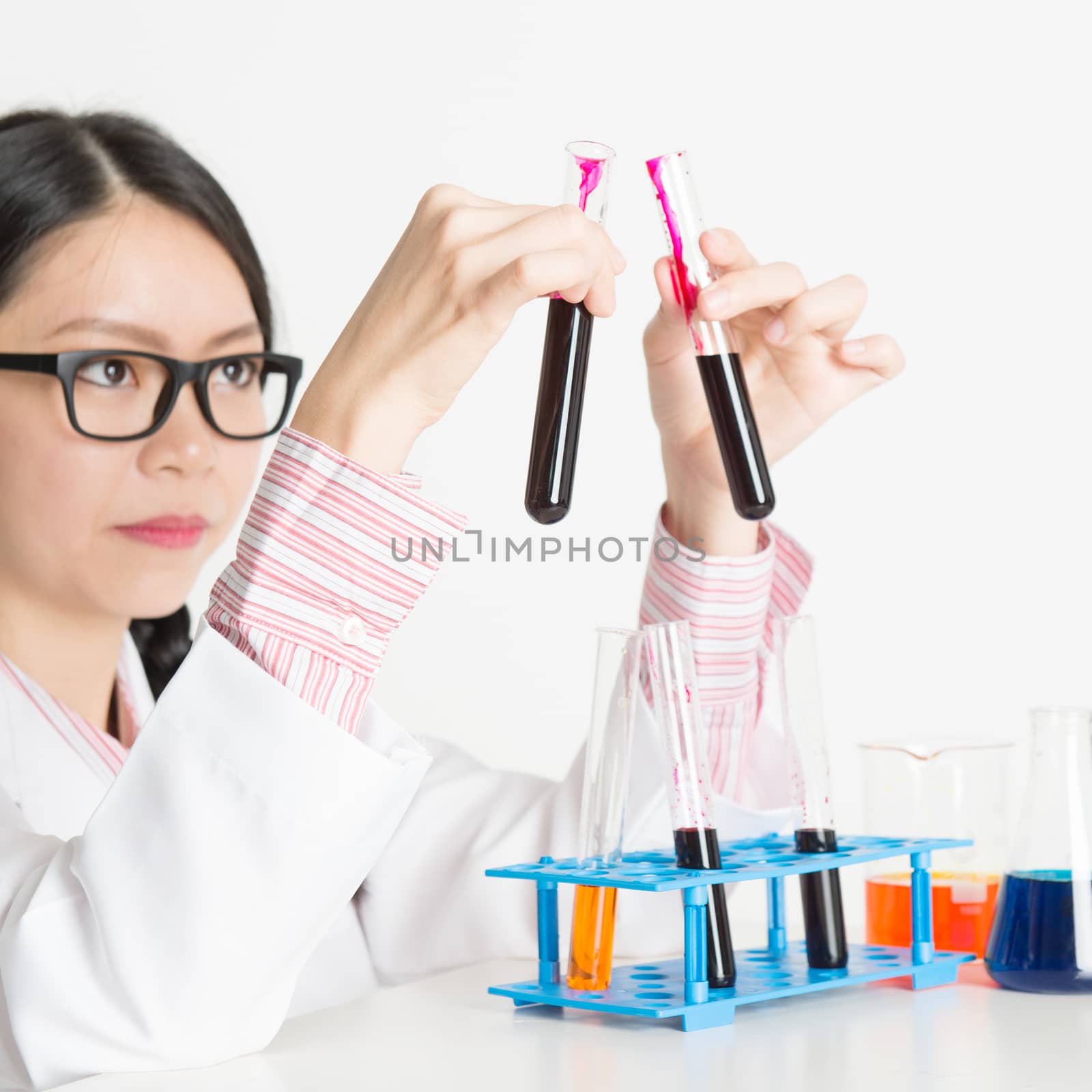 Asian lab worker doing blood test by szefei