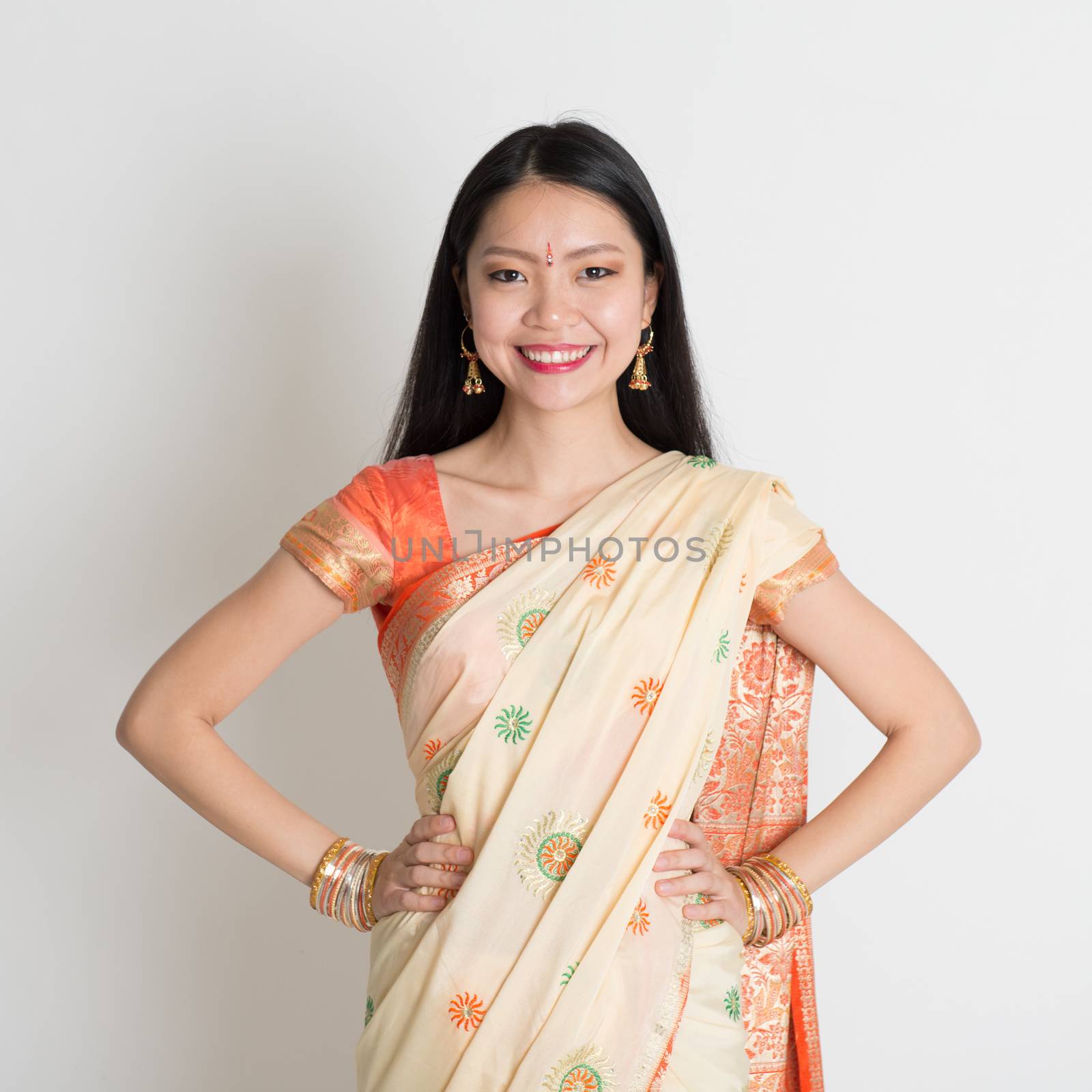 Confident Indian girl in sari smiling  by szefei