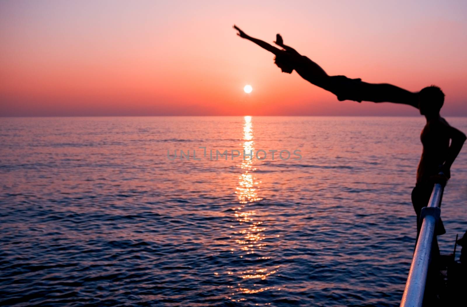 boy jumping into the sea, out of focus