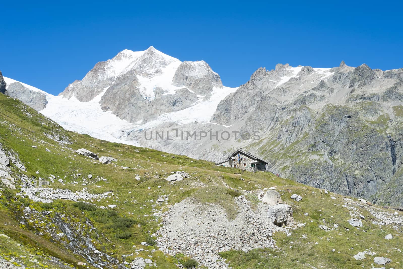 VAL VENY, ITALY - AUGUST 27: Elisabetta Soldini Refuge with Glaciers Needles in the background. The refuge is on a stage of the popular Mont Blanc tour. August 27, 2014 in Val Veny.