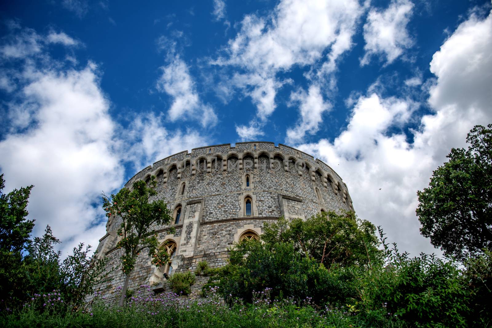 Windsor Castle is a royal residence at Windsor in the English county of Berkshire. It is notable for its long association with the English and British royal family and also for its architecture. The original castle was built in the 11th century after the invasion by William the Conqueror. 

Since the time of Henry I, it has been used by succeeding monarchs and is the longest-occupied palace in Europe. The castle's lavish, early 19th century State Apartments are architecturally significant, and is described as a superb and unrivalled sequence of rooms widely regarded as the finest and most complete expression of later Georgian taste.

Photographed using Nikon-D800E (36 megapixels) DSLR with AF-S NIKKOR 24-70 mm f/2.8G ED lens at focal length 24 mm, ISO 100, and exposure 1/1600 sec at f/2.8.