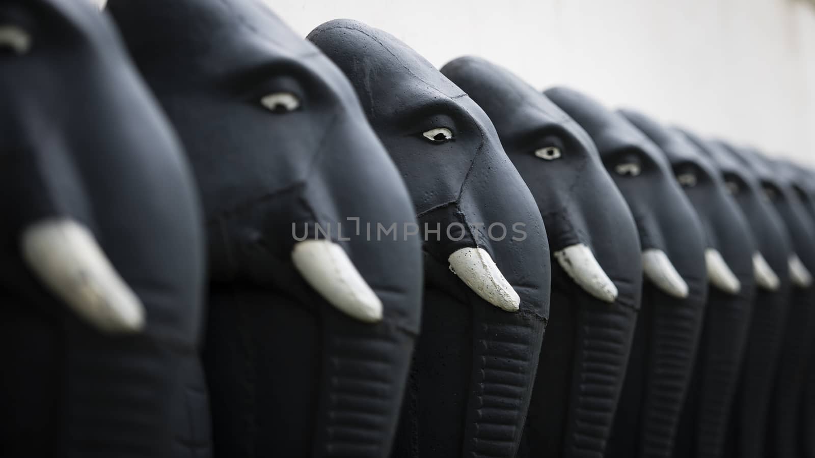 A row of frontline elephants sculptures at the temple.

Photographed using Nikon-D800E (36 megapixels) DSLR with AF-S NIKKOR 70-200 mm f/2.8G ED VR II lens at focal length 122 mm, ISO 100, and exposure 1/250 sec at f/2.8.