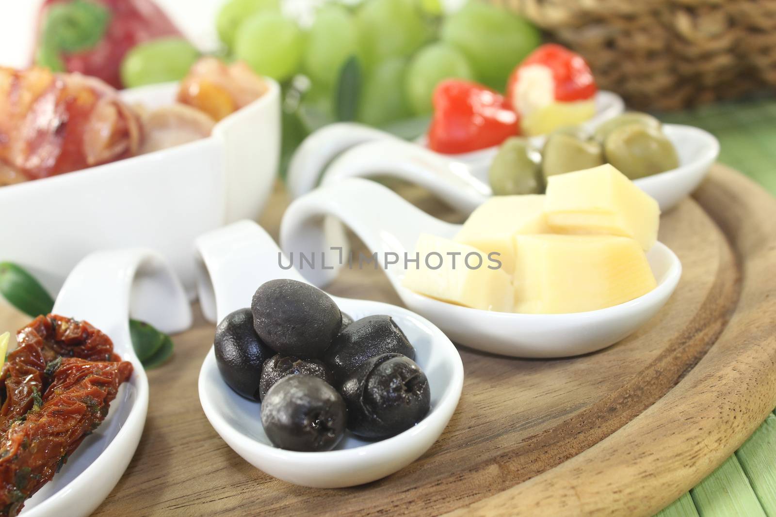 Tapas stuffed with prunes, figs, apricots and bacon on a light background