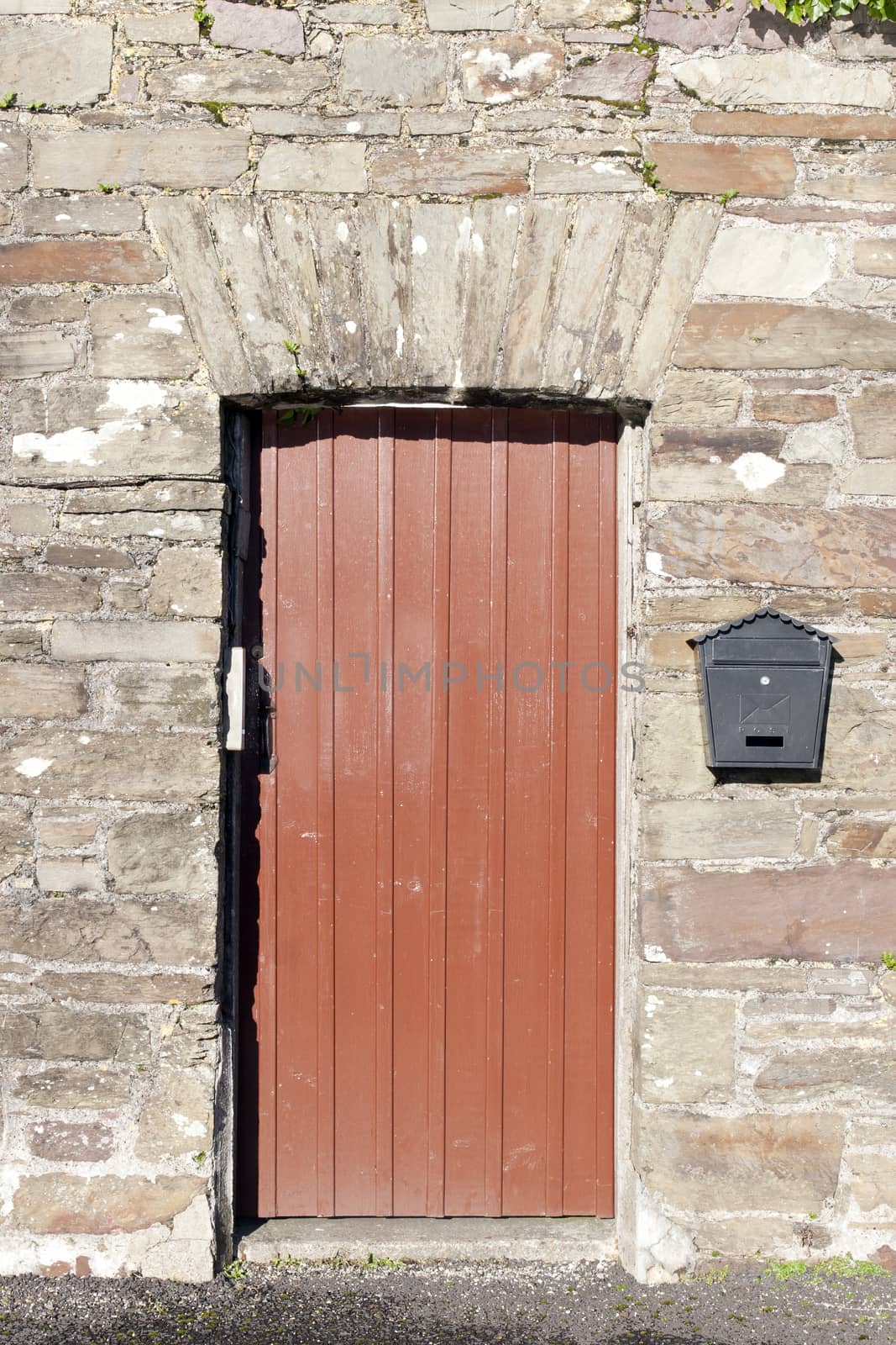 brown wooden doorway and a post box by morrbyte