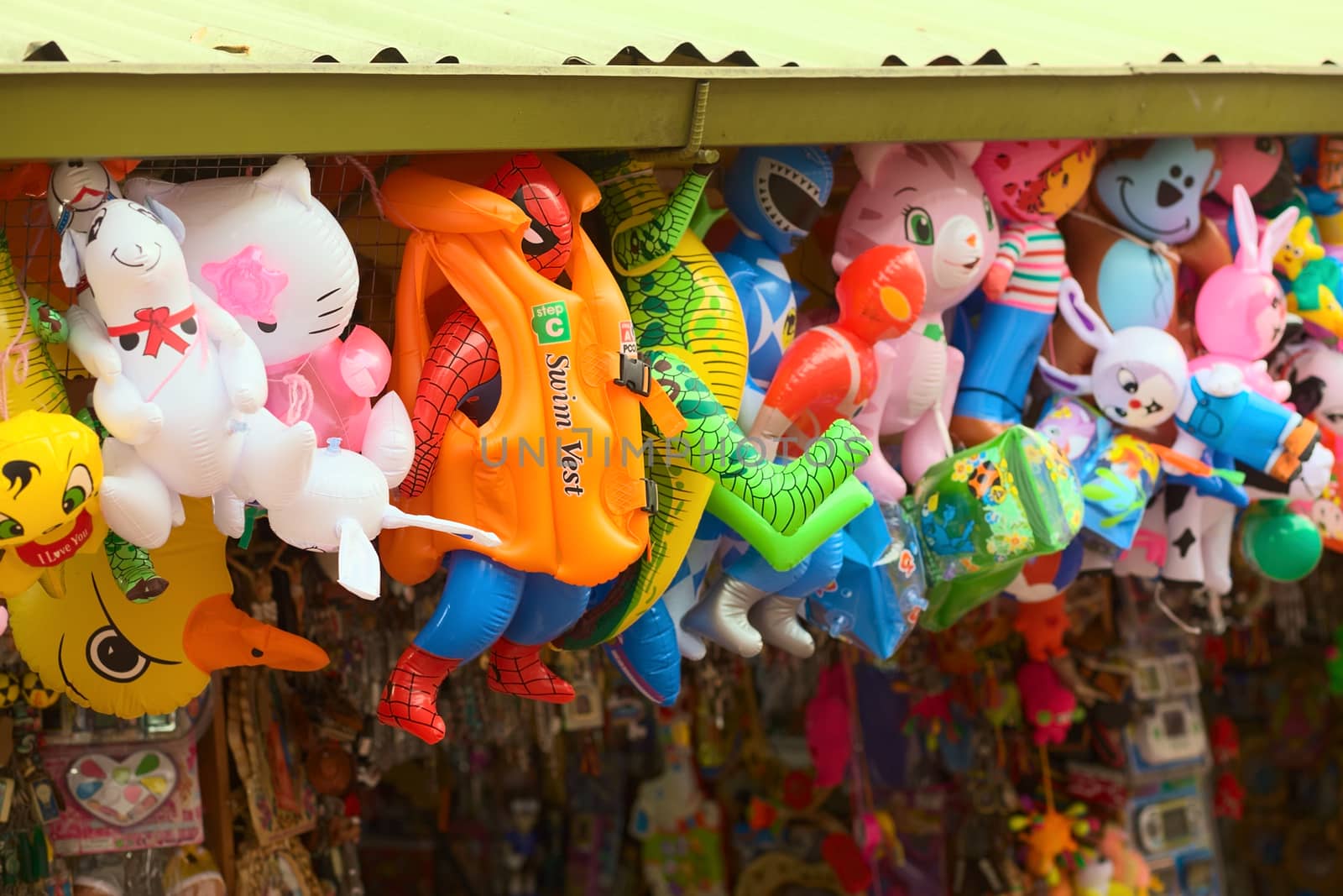 BANOS, ECUADOR - FEBRUARY 22, 2014: Floaties, such as water wings, life vest and inflatable animals and figures hanging at a toy stand at the Sebastian Acosta Park on February 22, 2014 in Banos, Ecuador.