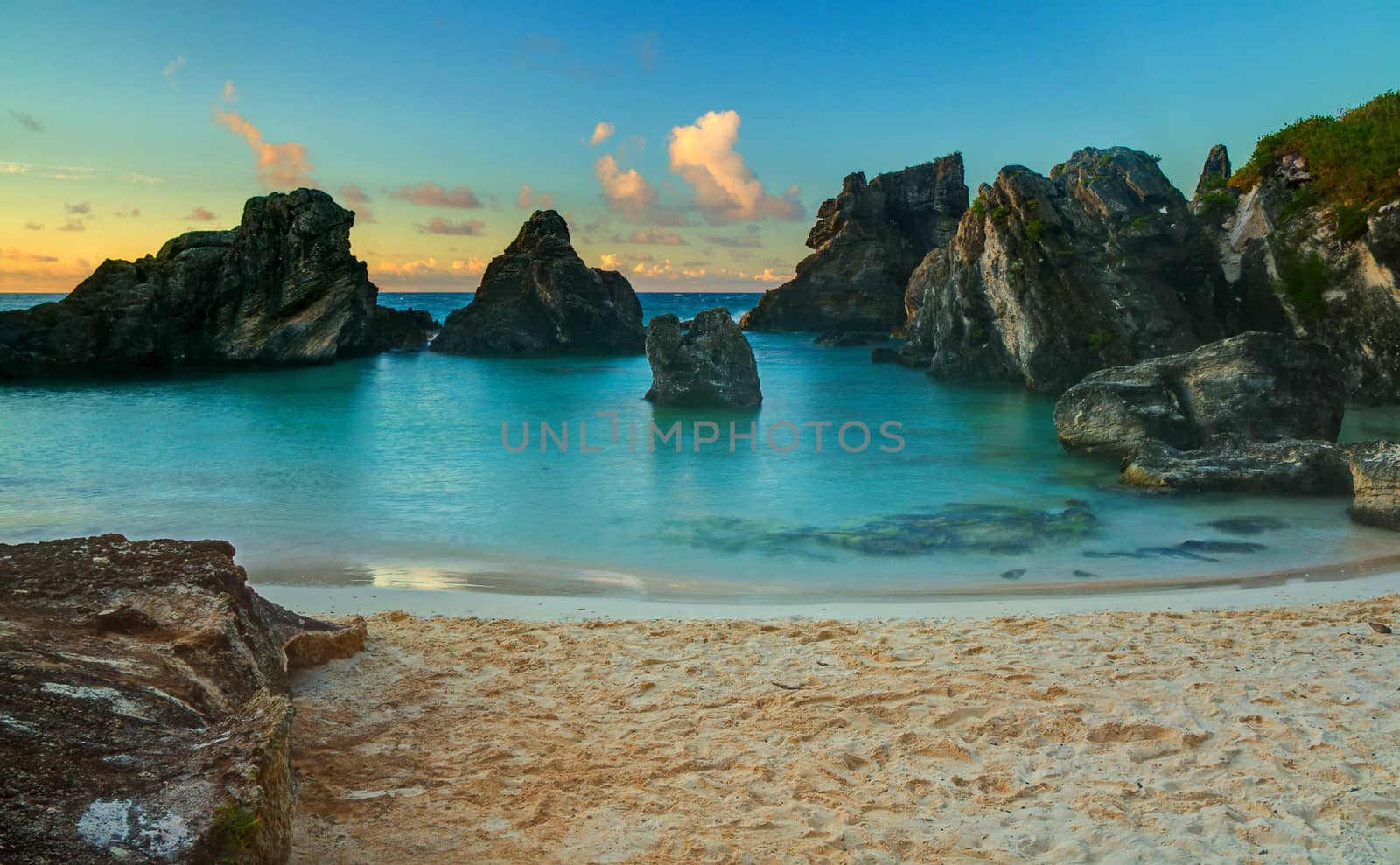 A calm, tropical cove at sunrise