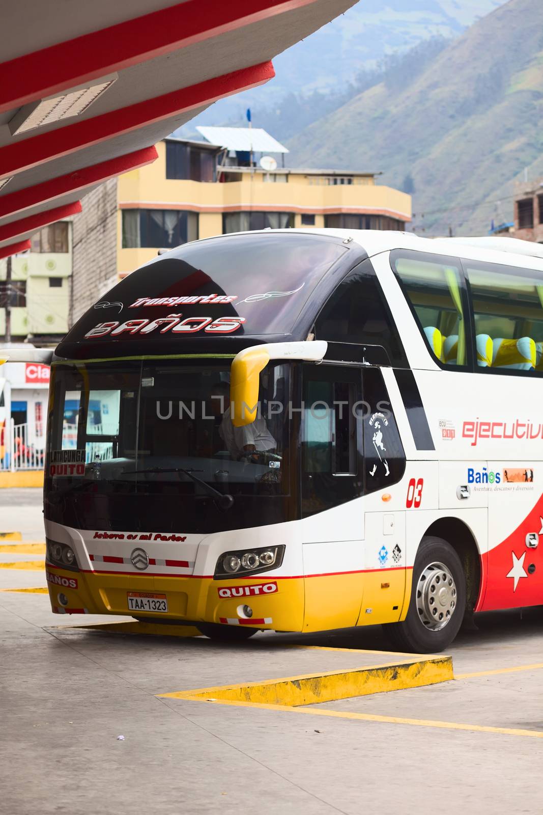 BANOS, ECUADOR - FEBRUARY 22, 2014: Unidentified person in a standing bus in the bus terminal on February 22, 2014 in Banos, Ecuador. 