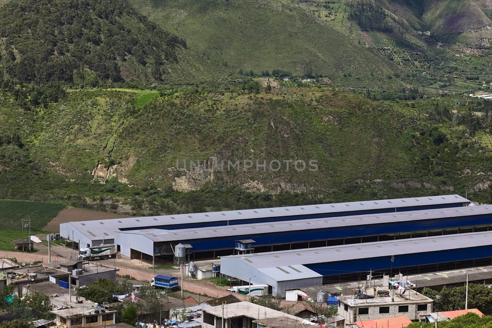 TUNGURAHUA PROVINCE, ECUADOR - JULY 29, 2014: Long agricultural or industrial halls along the road between Pelileo and Banos on July 29, 2014 in Tungurahua Province, Central Ecuador.