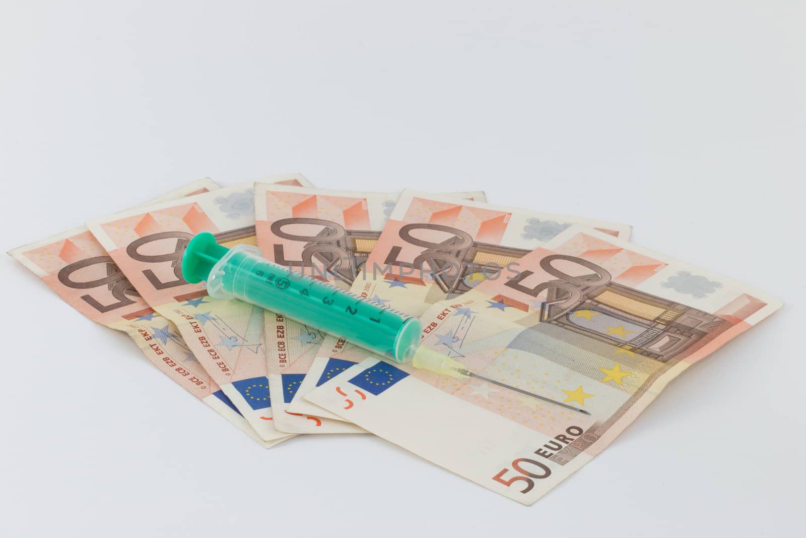 Drug trafficking, syringe, Euro bills by MarkDw