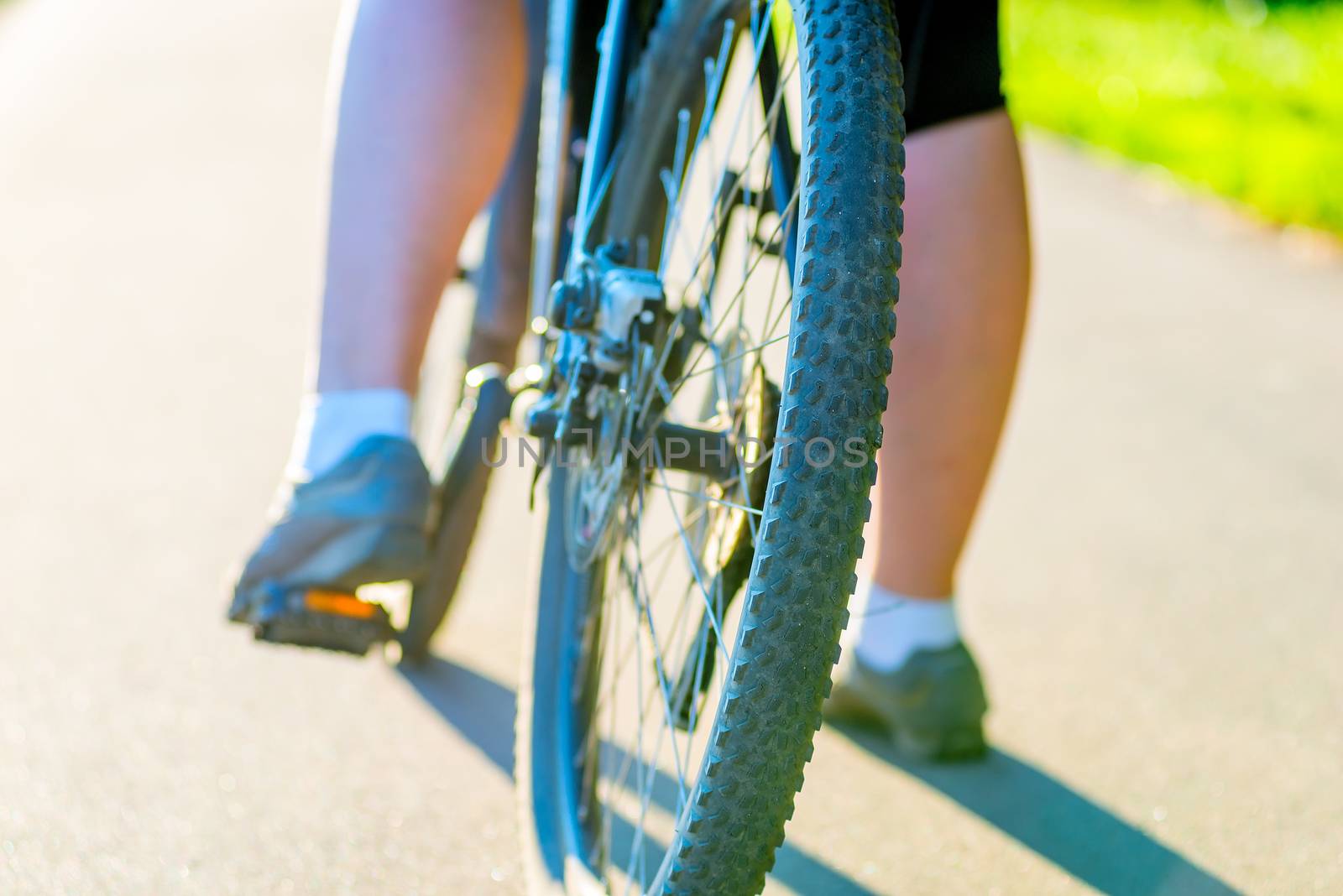 bicycle wheel and foot girl close-up