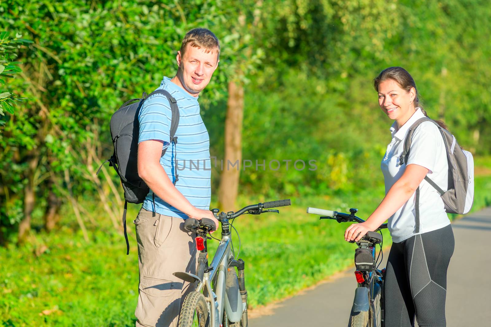 happy young people riding bikes