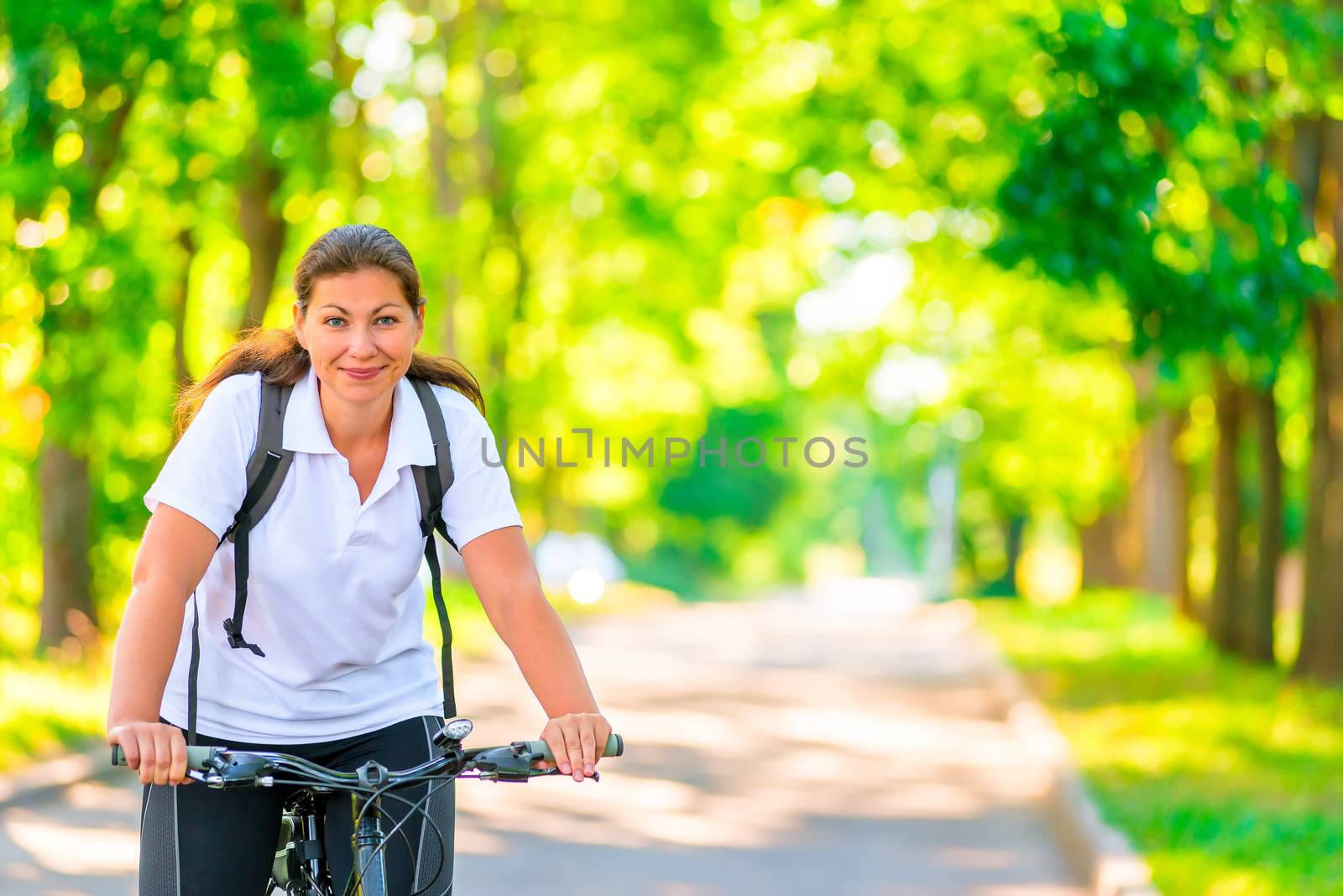 cheerful beautiful cyclist riding a bike by kosmsos111