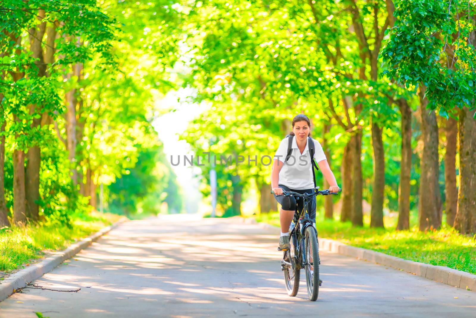 young girl on a bicycle in a park in the early morning by kosmsos111