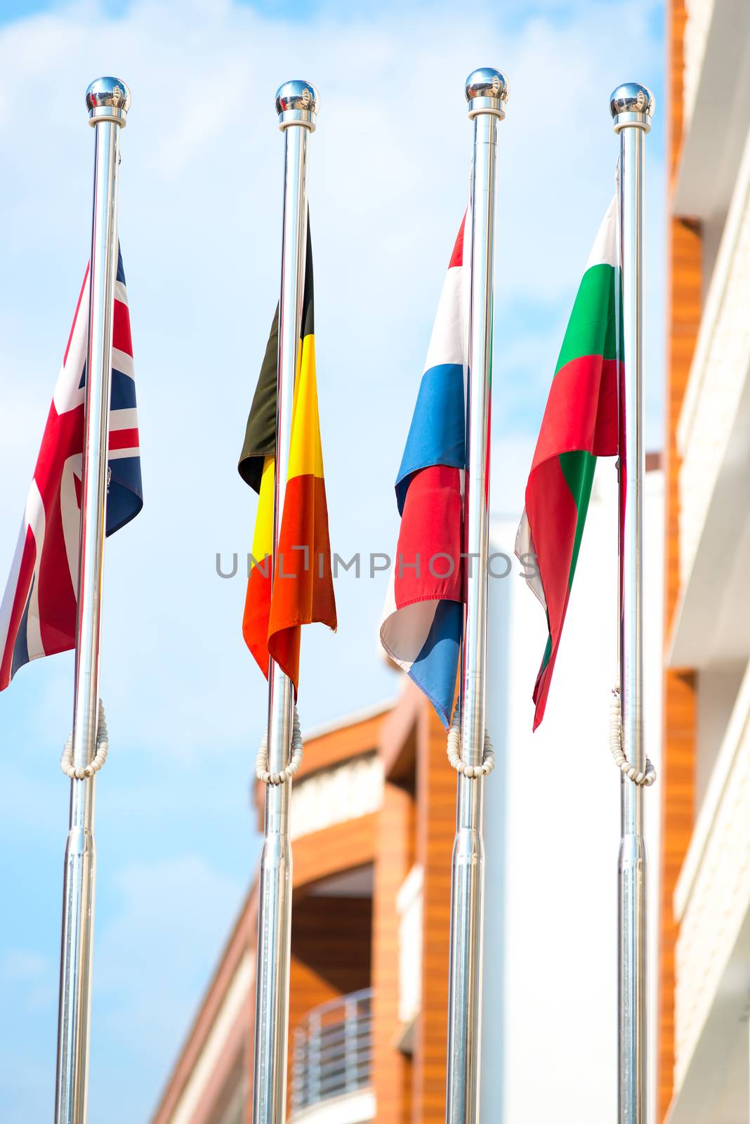 Vertical picture of national flags on sky background by kosmsos111