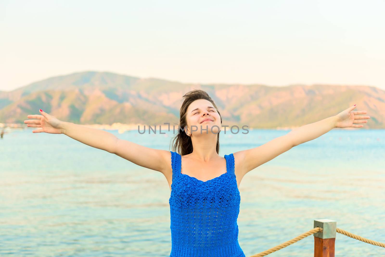 happy brunette near the sea enjoying vacation