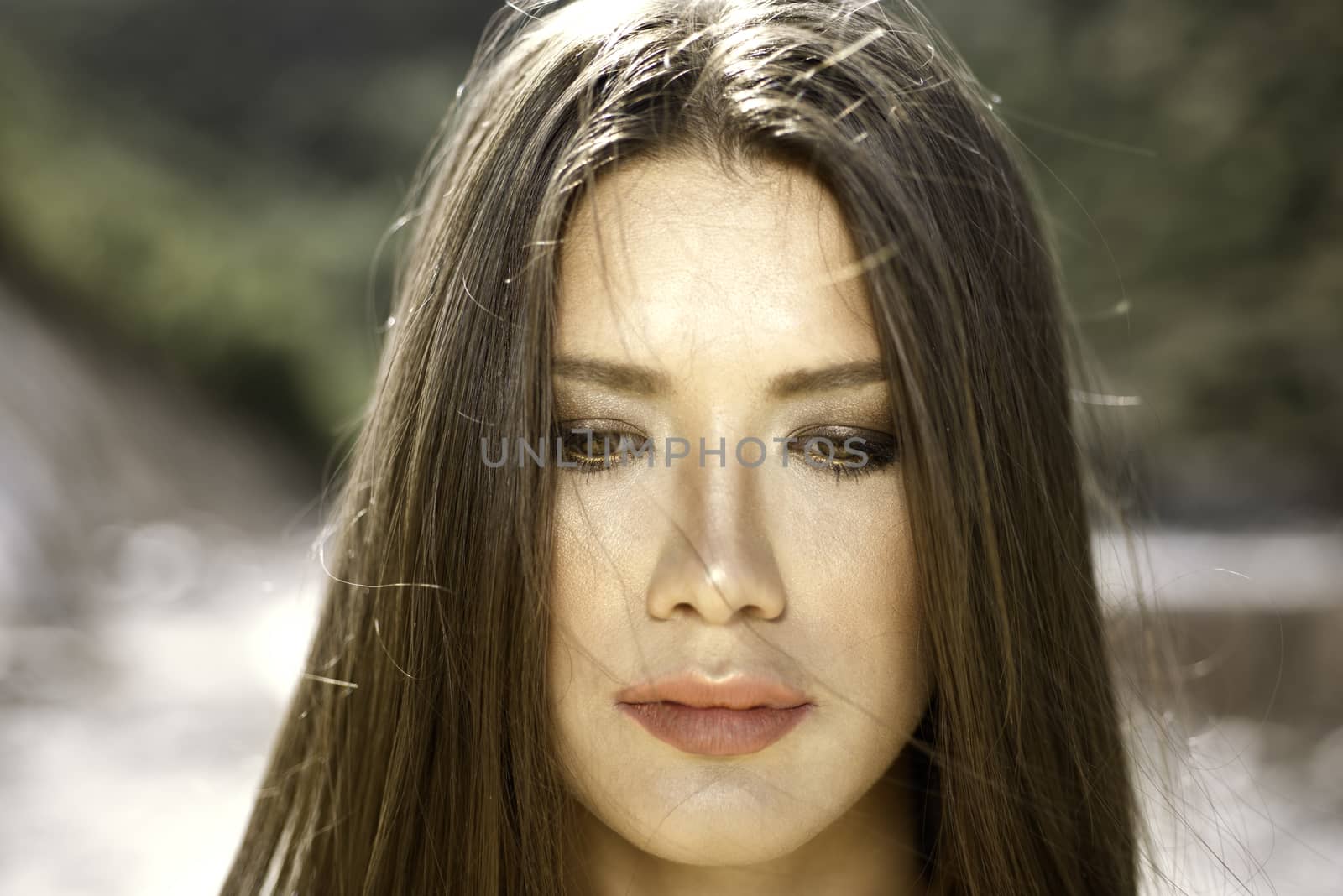 Close headshot portrait of a brown eye girl with golden light