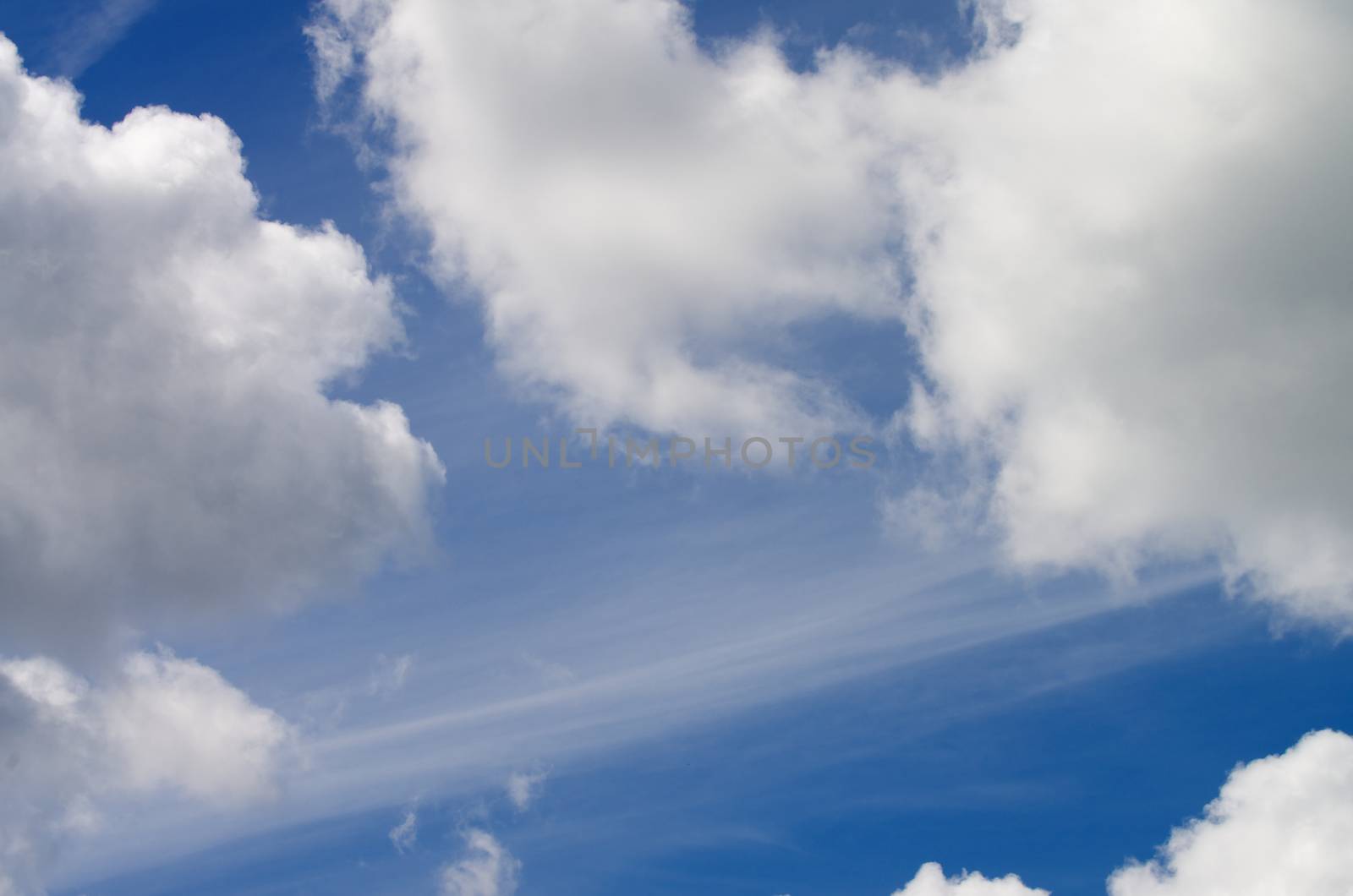 Fluffy White Clouds on Blue Sunny Sky Outdoors as Frame
