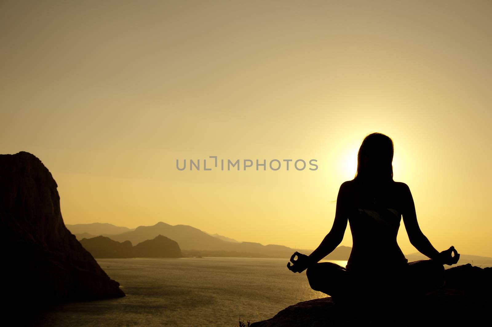 Yoga lotus position silhouette on seaside by dred