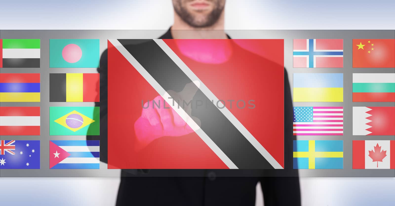 Hand pushing on a touch screen interface, choosing language or country, Trinidad and Tobago